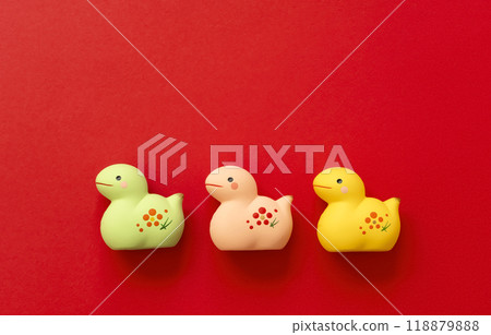 New Year's material. The zodiac sign of the snake. A snake figurine on a red background 118879888