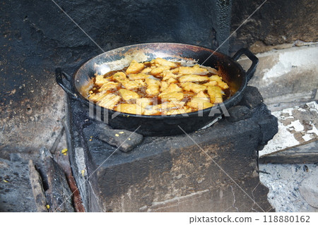 Fried tofu in a pan on the fire. Selective focus. Fried tofu in a pan on the fire. Selective focus. 118880162