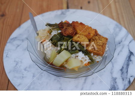 A plate of food on a table, a delicious meal consisting of various dishes arranged neatly on a plate. A plate of food on a table, a delicious meal consisting of various dishes arranged neatly on a plate. 118880313