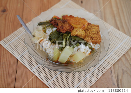 A plate of food on a table, a delicious meal consisting of various dishes arranged neatly on a plate. A plate of food on a table, a delicious meal consisting of various dishes arranged neatly on a plate. 118880314