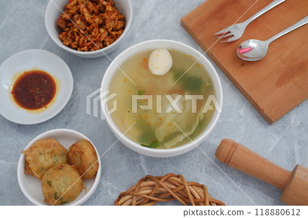 Creamy soup in a white bowl, with delicious side dishes 118880612