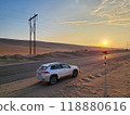 SUV in front of a sunset in a desert landscape in southern Peru 118880616
