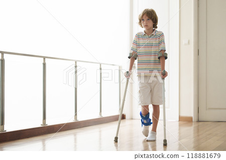 Injured child on crutches. Boy in cast on foot 118881679