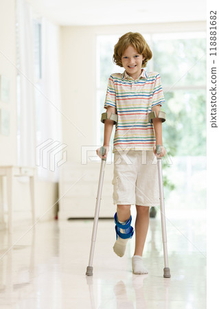Injured child on crutches. Boy in cast on foot 118881682