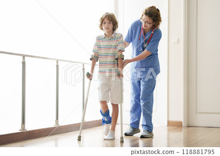 Injured child on crutches. Boy in cast on foot 118881795