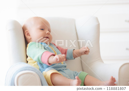 Little baby on white chair Little baby on white chair 118881807