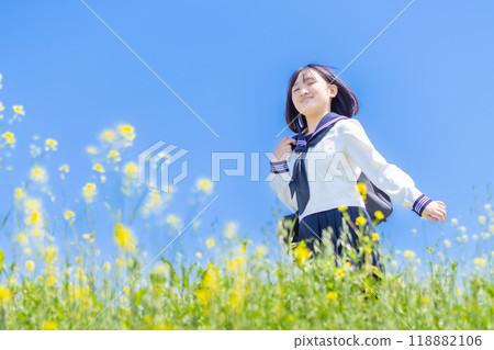 Portrait of a smiling high school girl in a flower field Portrait of a smiling high school girl in a flower field 118882106