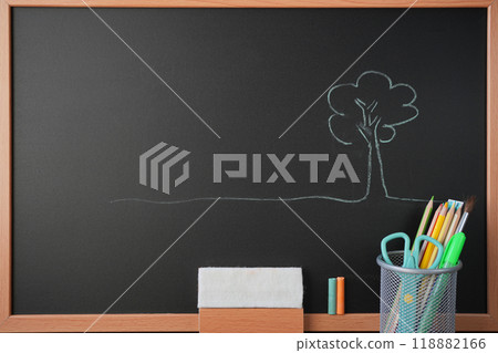 Tree drawing on blackboard with stationery, chalk and eraser 118882166