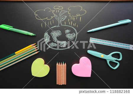 earth doodle with stationery on black chalkboard earth doodle with stationery on black chalkboard 118882168