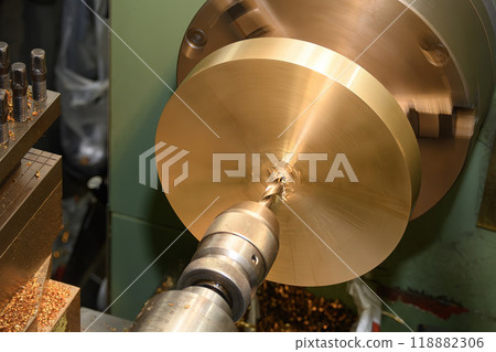 The hole drilling process on brass material parts by lathe machine. 118882306
