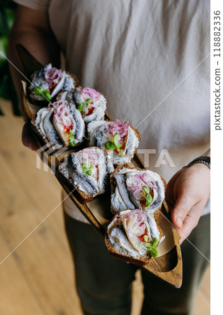 Open-faced fish sandwiches with cream cheese and pickled onions, perfect for cafes, restaurants Open-faced fish sandwiches with cream cheese and pickled onions, perfect for cafes, restaurants 118882336