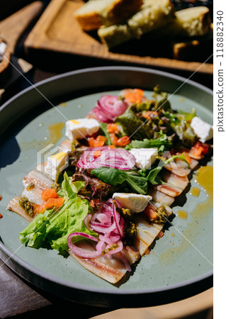 Fresh salad with smoked fish, pickled onions, and creamy cheese for gourmet dining experience 118882340