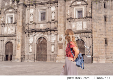 Female tourist in front of Catedral de Puebla, Mexico. Travel, cultural heritage, and historic architecture exploration concept Female tourist in front of Catedral de Puebla, Mexico. Travel, cultural heritage, and historic architecture exploration concept 118882544