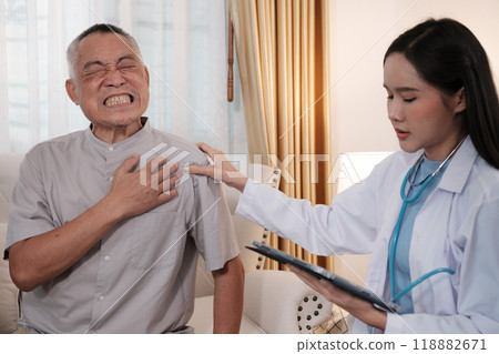 A female doctor examines an elderly patient with neck pain. 118882671