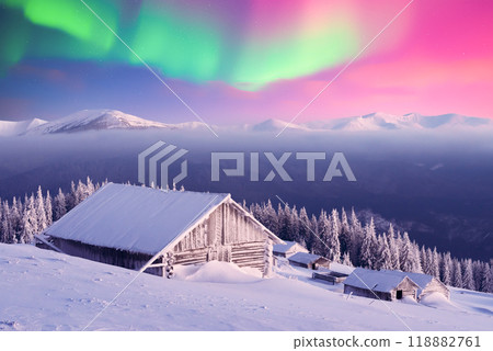 Old wooden cabins in snowy mountains under incredible Northern lights Old wooden cabins in snowy mountains under incredible Northern lights 118882761