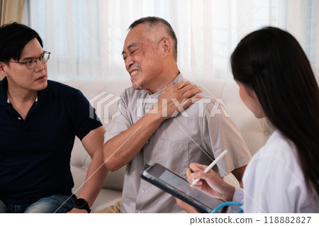 A female doctor examines an elderly patient with neck pain. A female doctor examines an elderly patient with neck pain. 118882827
