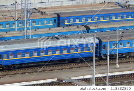 Passenger railway carriages stand on sidetracks waiting for a train to be formed Passenger railway carriages stand on sidetracks waiting for a train to be formed 118882890