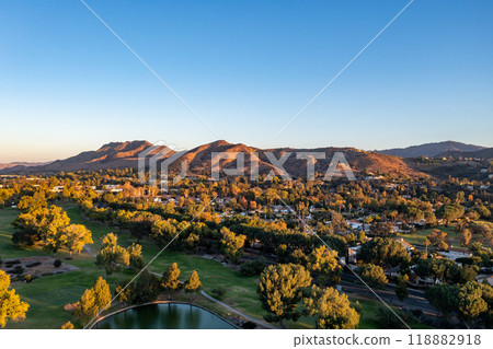 Aerial view of a stunning lake, surrounded by trees and mountains 118882918