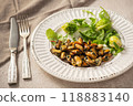 Mussels cooked in coconut oil served with greens and Brussels sprouts 118883140