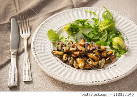 Mussels cooked in coconut oil served with greens and Brussels sprouts Mussels cooked in coconut oil served with greens and Brussels sprouts 118883140