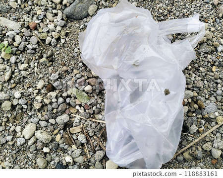 White plastic bag lying on sandstone, Used white plastic bags, plastic trash 118883161