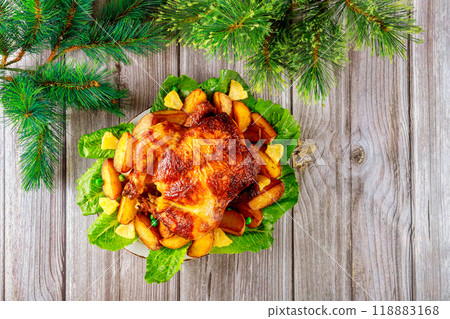 In celebration of Christmas, table is adorned with baked chicken In celebration of Christmas, table is adorned with baked chicken 118883168