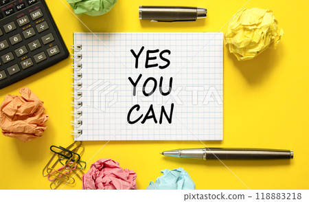 Motivational Yes you can symbol. Concept words Yes you can on beautiful white note. Beautiful yellow background. Black pen. Calculator. Business motivational and Yes you can concept. Copy space Motivational Yes you can symbol. Concept words Yes you can on beautiful white note. Beautiful yellow background. Black pen. Calculator. Business motivational and Yes you can concept. Copy space 118883218