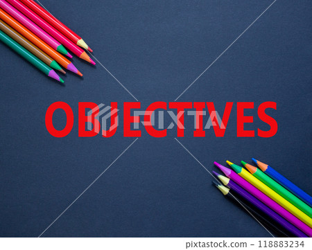 Objectives symbol. Concept word Objectives on beautiful black paper. Beautiful black paper background. Colored pencils. Business objectives concept. Copy space. 118883234