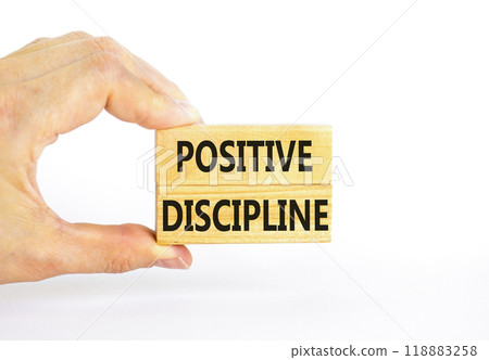 Positive discipline symbol. Concept words Positive discipline on beautiful wooden blocks. Beautiful white background. Businessman hand. Business psychology positive discipline concept. Copy space. 118883258