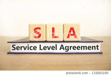 SLA service level agreement symbol. Concept words SLA service level agreement on beautiful wooden blocks and book. Beautiful white background. Business SLA service level agreement concept. Copy space. SLA service level agreement symbol. Concept words SLA service level agreement on beautiful wooden blocks and book. Beautiful white background. Business SLA service level agreement concept. Copy space. 118883280