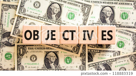 Objectives symbol. Concept word Objectives on beautiful wooden blocks. Dollar bills. Beautiful background from dollar bills. Business objectives concept. Copy space. Objectives symbol. Concept word Objectives on beautiful wooden blocks. Dollar bills. Beautiful background from dollar bills. Business objectives concept. Copy space. 118883319