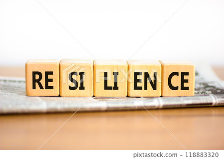 Resilience symbol. Concept word Resilience on beautiful wooden blocks. Beautiful wooden table white background. Newspaper. Business resilience concept. Copy space. Resilience symbol. Concept word Resilience on beautiful wooden blocks. Beautiful wooden table white background. Newspaper. Business resilience concept. Copy space. 118883320