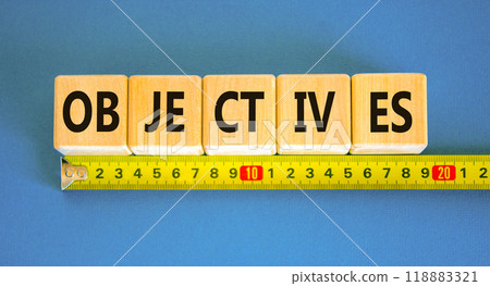 Objectives symbol. Concept word Objectives on beautiful wooden blocks. Beautiful blue background. Beautiful yellow ruler. Business objectives concept. Copy space. 118883321