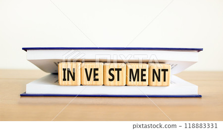 Investment symbol. Concept word Investment on beautiful wooden cubes in book. Beautiful wooden table white background. Business investment concept. Copy space. Investment symbol. Concept word Investment on beautiful wooden cubes in book. Beautiful wooden table white background. Business investment concept. Copy space. 118883331