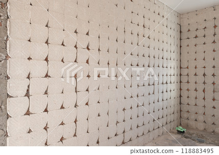 Abstract background of interior wall being renovated with exposed concrete tile backing Abstract background of interior wall being renovated with exposed concrete tile backing 118883495