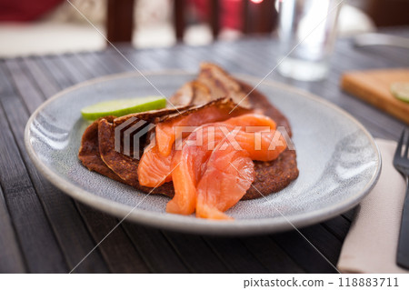 Salted salmon fillet with rye pancakes and lime 118883711