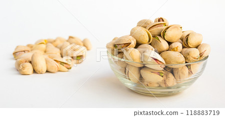 Roasted pistachios on white background Roasted pistachios on white background 118883719