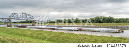 Towboat with barges is passing under a bridge on the Chain of Rocks Canal of MIssissippi River above St Louis 118883879