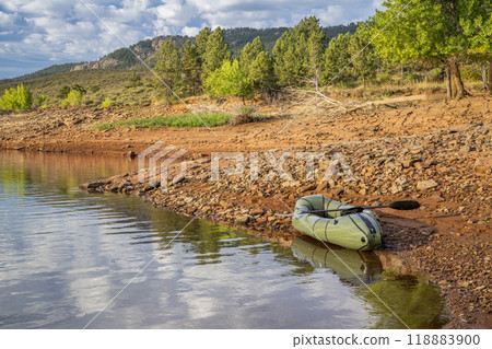 inflatable packraft (one-person light raft used for expedition or adventure racing) with a paddle on a lake shore in Colorado, summer on Horsetooth Reservoir 118883900