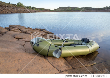 inflatable packraft (one-person light raft used for expedition or adventure racing) with a paddle on a lake shore in Colorado, summer on Horsetooth Reservoir 118883912