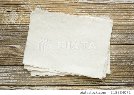 blank watercolor paper against grunge wooden background blank watercolor paper against grunge wooden background 118884071