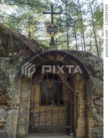 Rock chapel Holy Trinity carved into the sandstone rock near Ceska Kamenice town in Lusatian Mountains forest Rock chapel Holy Trinity carved into the sandstone rock near Ceska Kamenice town in Lusatian Mountains forest 118884169