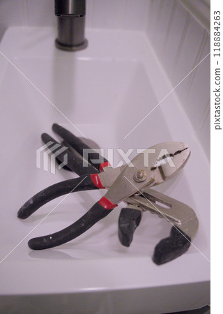 Pliers tools in bathroom sink 118884263