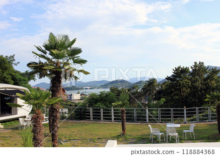 Sacheon City, Gyeongsangnam-do, Republic of Korea - August 18, 2024: Dad, son and daughter having fun playing in the water at a resort pool with a sea view. Sacheon City, Gyeongsangnam-do, Republic of Korea - August 18, 2024: Dad, son and daughter having fun playing in the water at a resort pool with a sea view. 118884368