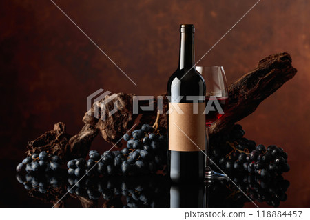 Red wine with an old snag and blue grapes. 118884457