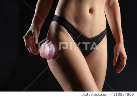 woman using Silicone Anti-Cellulite Vacuum Massage Cups for Self-Massage close-up on body, 118884809