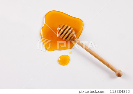 honey spoon with spilled honey on white background, top view honey spoon with spilled honey on white background, top view 118884853