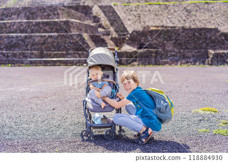 Toddler and teenage boys exploring Teotihuacan, Mexico. Cultural heritage, ancient ruins, and archaeological adventure concept Toddler and teenage boys exploring Teotihuacan, Mexico. Cultural heritage, ancient ruins, and archaeological adventure concept 118884930
