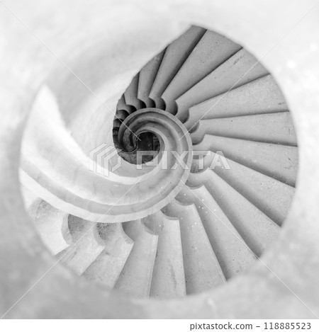 The helical staircase features smooth, sculptural lines that spiral gracefully downward The helical staircase features smooth, sculptural lines that spiral gracefully downward 118885523