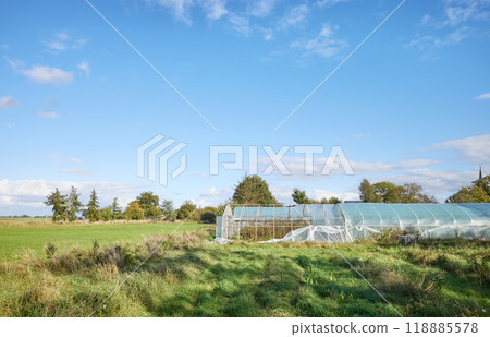 Rural landscape with polytunnel damaged by storm. Rural landscape with polytunnel damaged by storm. 118885578